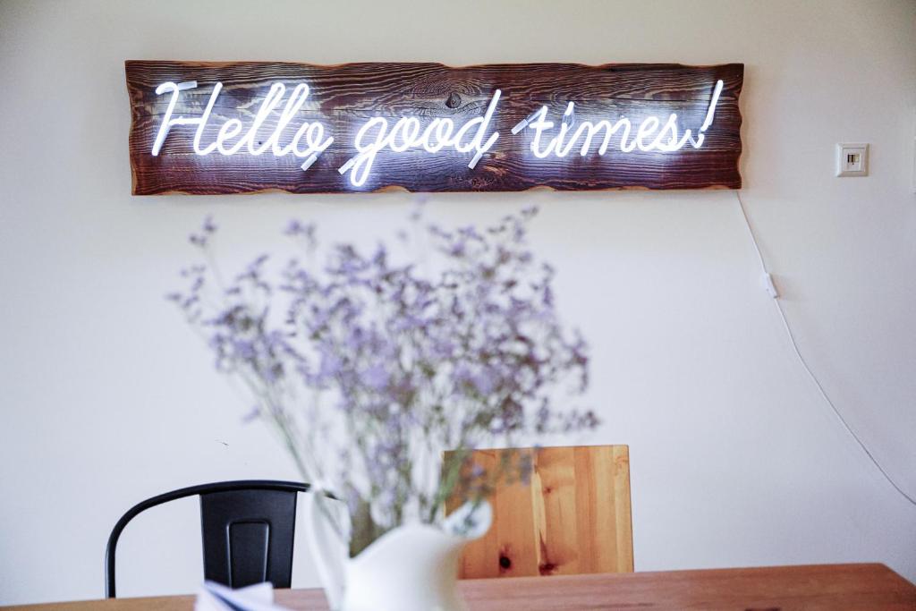 a sign hanging on a wall with a vase of flowers at Toferer Textil in Eben im Pongau