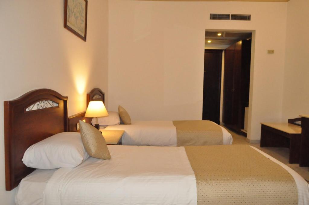 Postel nebo postele na pokoji v ubytování Dexon Roma Hotel
