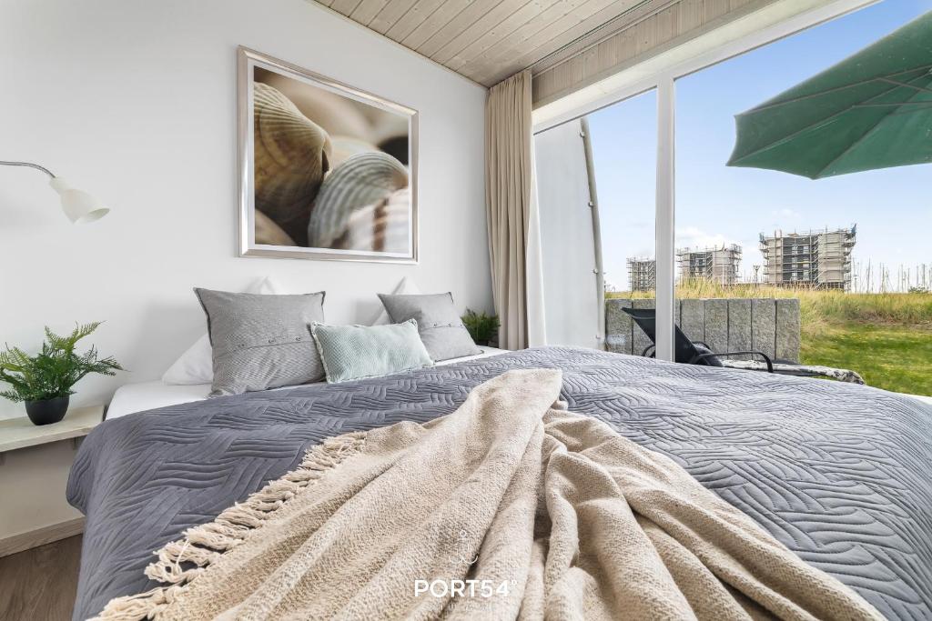 En eller flere senge i et værelse på Ferienhaus Ocean 15 Marina Wendtorf