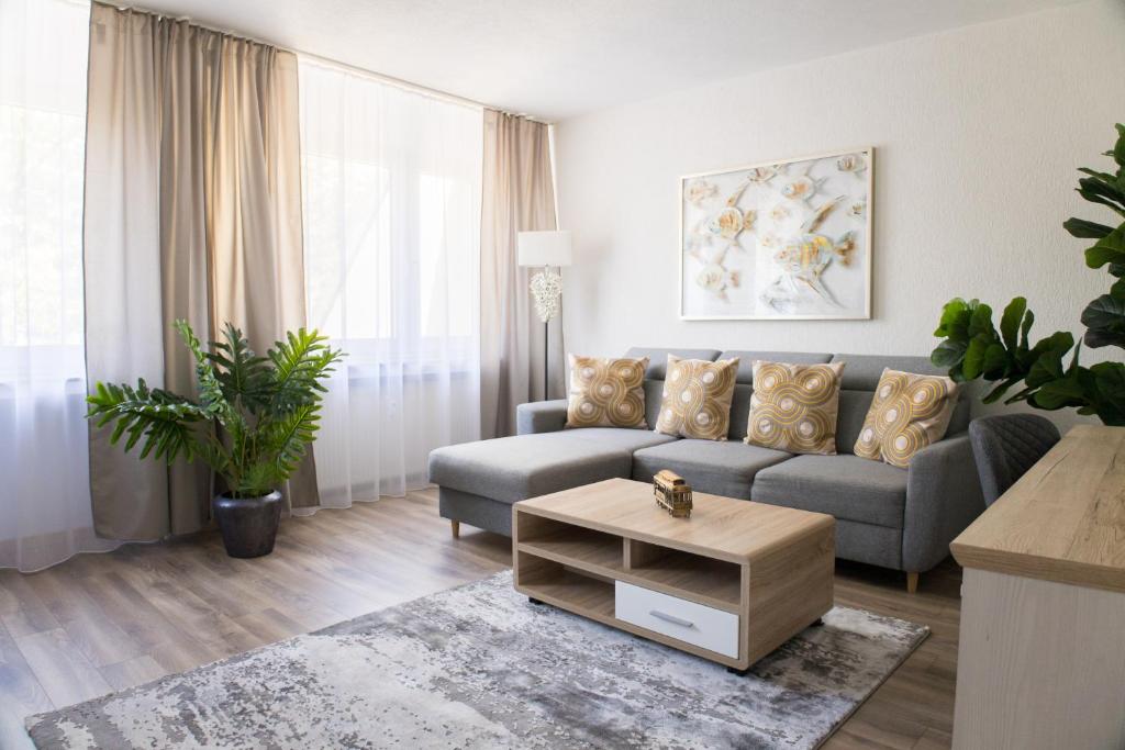 a living room with a couch and a coffee table at T&K Apartments near Messe Fair Trade Düsseldorf und Airport 2A in Duisburg