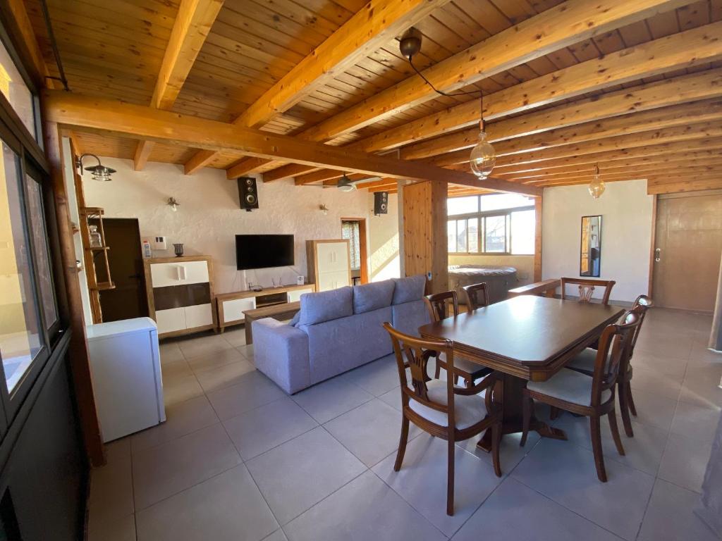 a living room with a table and a couch at El Olivar Fuerteventura Holidays in Puerto del Rosario