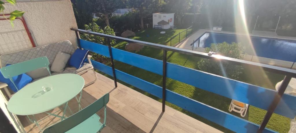 a balcony with a table and chairs and a swimming pool at Estudio LA paradise in Torremolinos