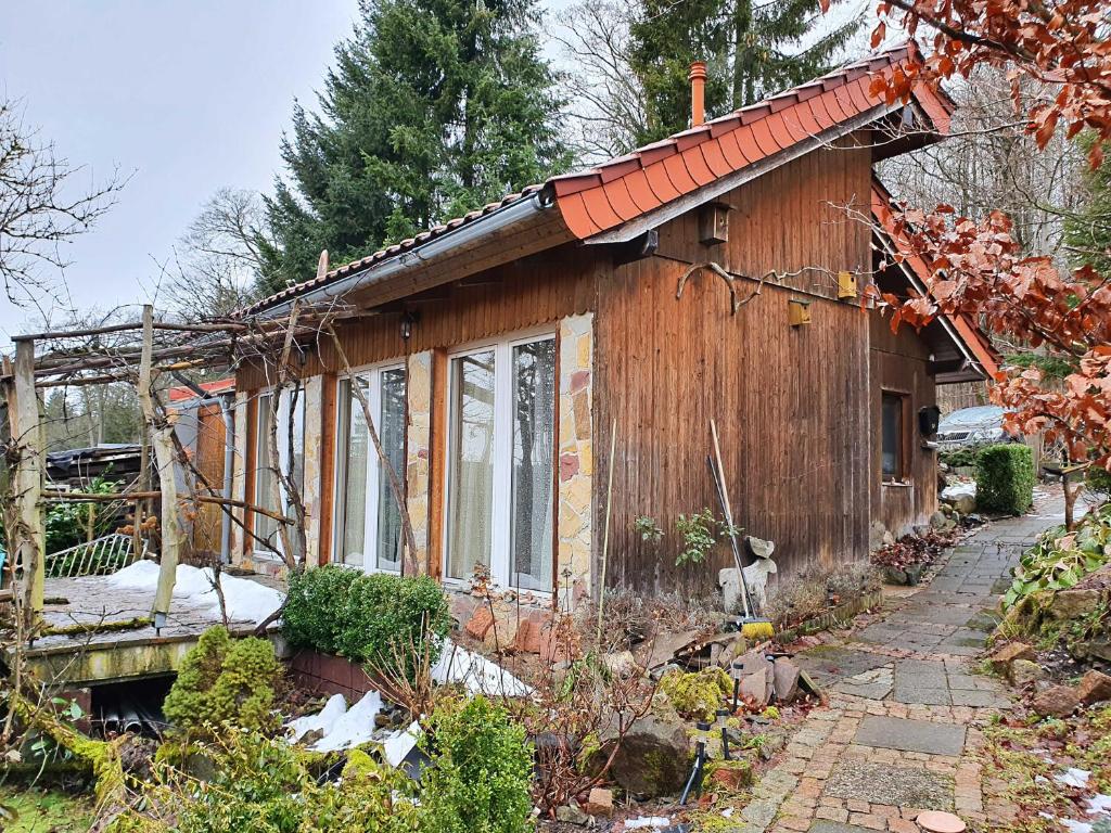 a small wooden house with a pathway in front of it at Haus Irina & Haus Anna in Elend