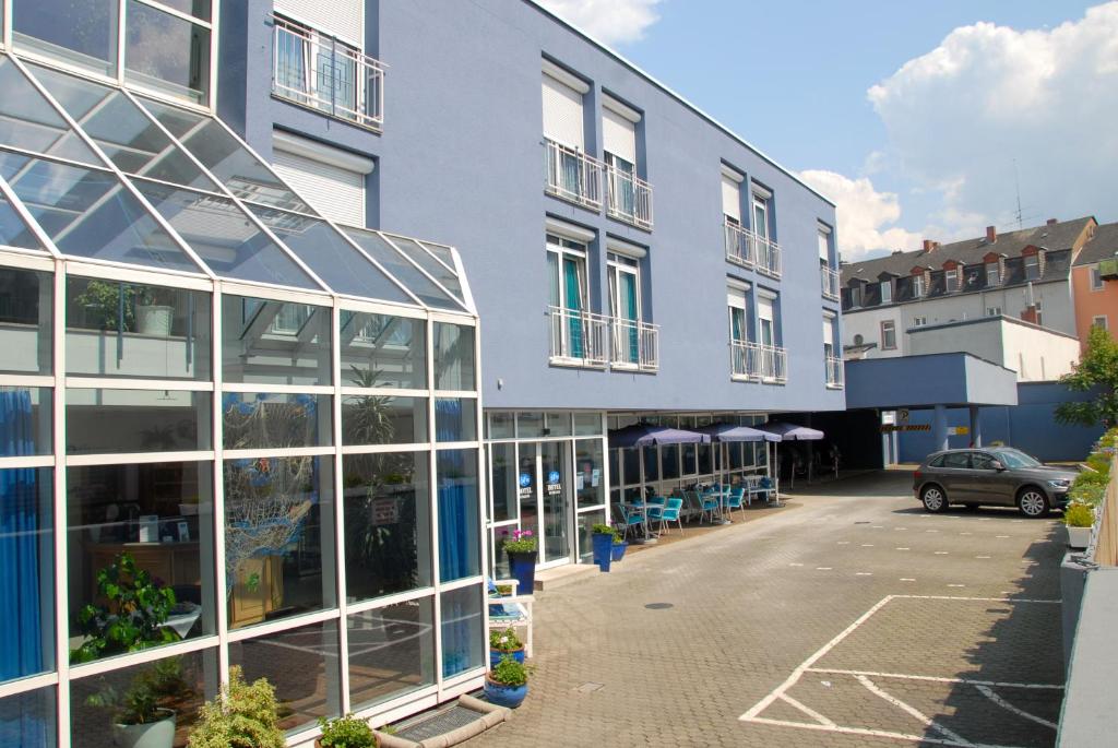 ein großes Gebäude mit vielen Glasfenstern in der Unterkunft Paulin Hotel Trier in Trier