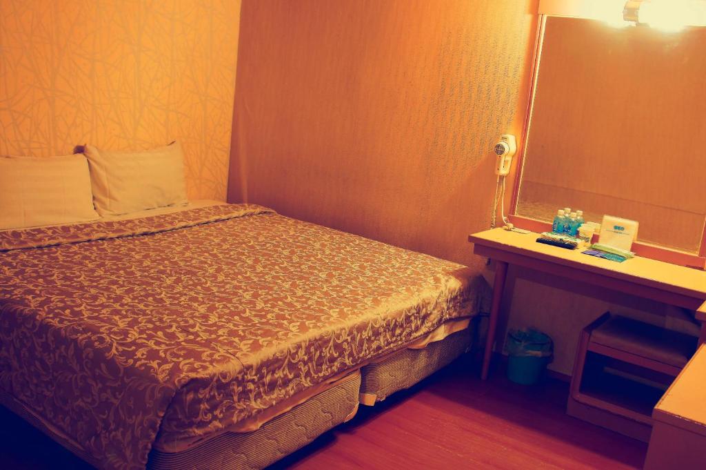 Postel nebo postele na pokoji v ubytování Li Duo Hotel