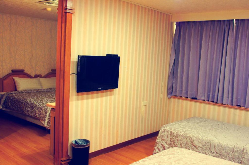 Postel nebo postele na pokoji v ubytování Li Duo Hotel