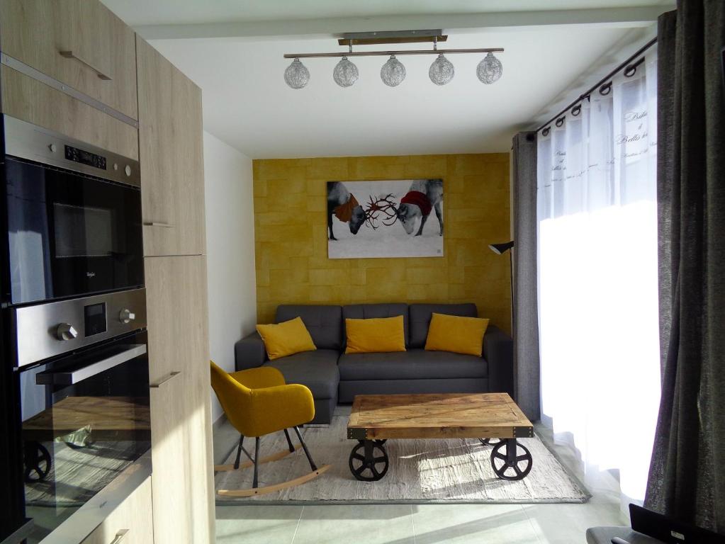 a living room with a couch and a table at Appartement de 4 chambres a Les Deux Alpes a 100 m des pistes avec jardin clos et wifi in Les Deux Alpes