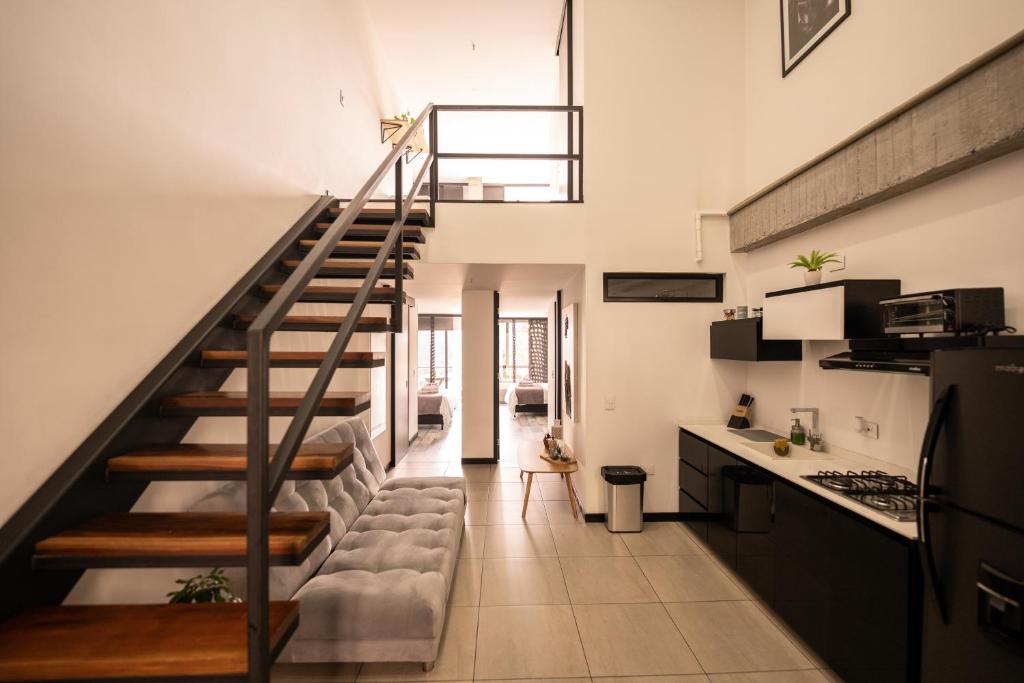 a staircase leading up to a kitchen and a living room at The Coffee Club in Manizales
