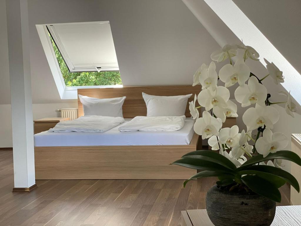 a bedroom with a bed with a window and a plant at Villa Am Park in Bad Homburg vor der Höhe