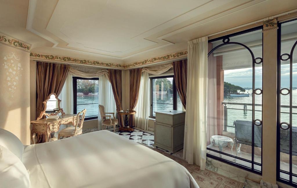 a bedroom with a large bed and a balcony at Hotel Cipriani, A Belmond Hotel, Venice in Venice