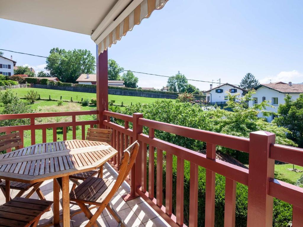 a patio with a table and chairs on a balcony at Appartement Moderne avec Balcon, Proche Centre et Plage, Piscine et Parking, Hendaye - FR-1-2-399 in Hendaye