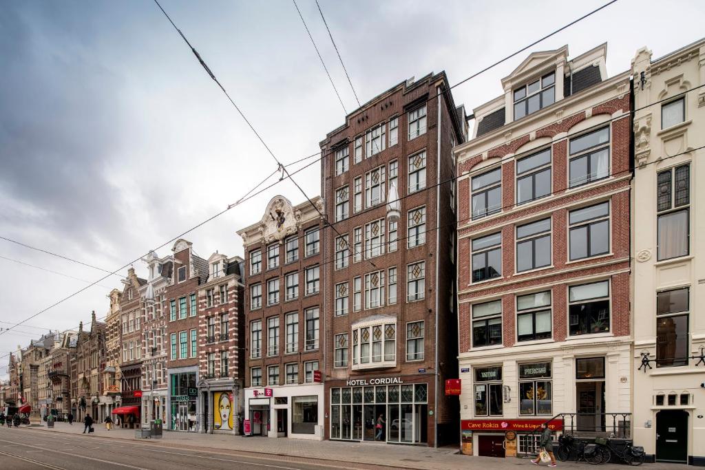 a row of tall buildings on a city street at OZO Hotels Cordial Amsterdam in Amsterdam