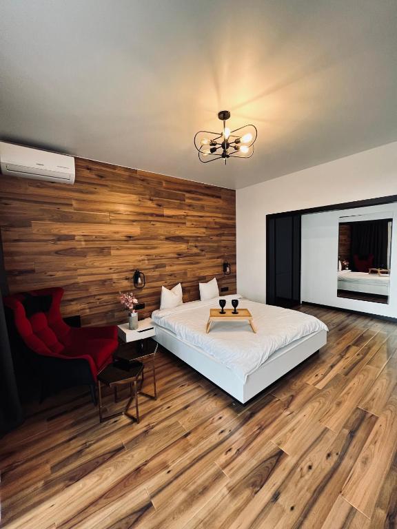 a bedroom with a bed and a wooden wall at Exclusive apartment Новобудова ЖК Театральний ЦЕНТР in Rivne