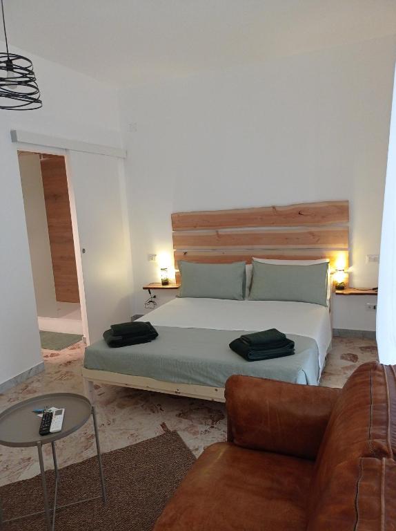 a bedroom with a large bed and a couch at CasaRA in Bari