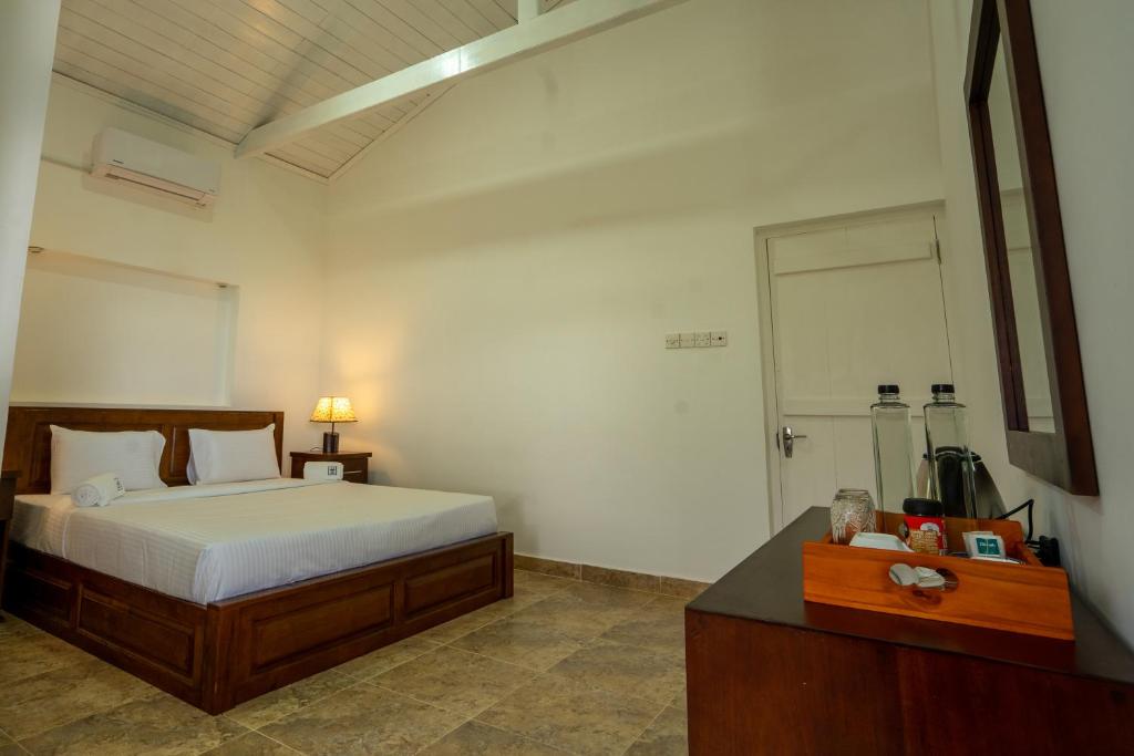Postel nebo postele na pokoji v ubytování Shiro in Kandy