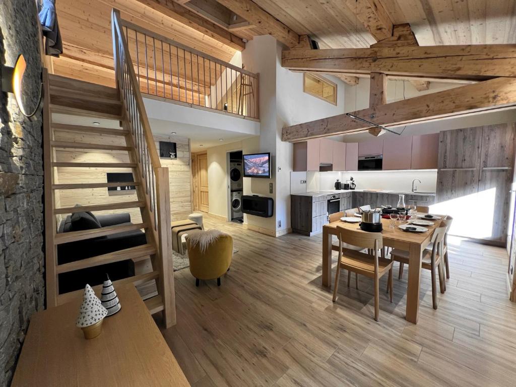 a kitchen and living room with a table and a dining room at POLARIS Bel appartement village et pistes in La Clusaz