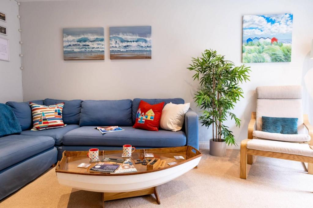 a living room with a blue couch and a coffee table at Number Two in Southampton