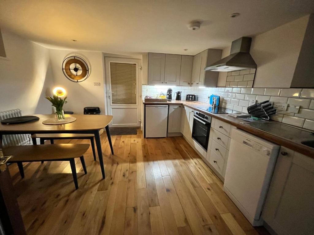 a kitchen with a table and a table and a dining room at The Old Chapel Manton 