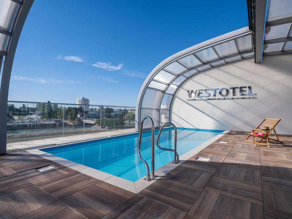 a swimming pool on the roof of a building at Westotel Le Pouliguen in Le Pouliguen