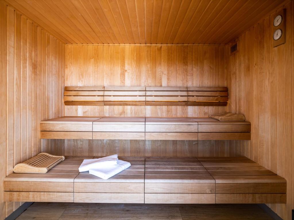 a sauna with wooden walls and a wooden floor at Westotel Le Pouliguen in Le Pouliguen