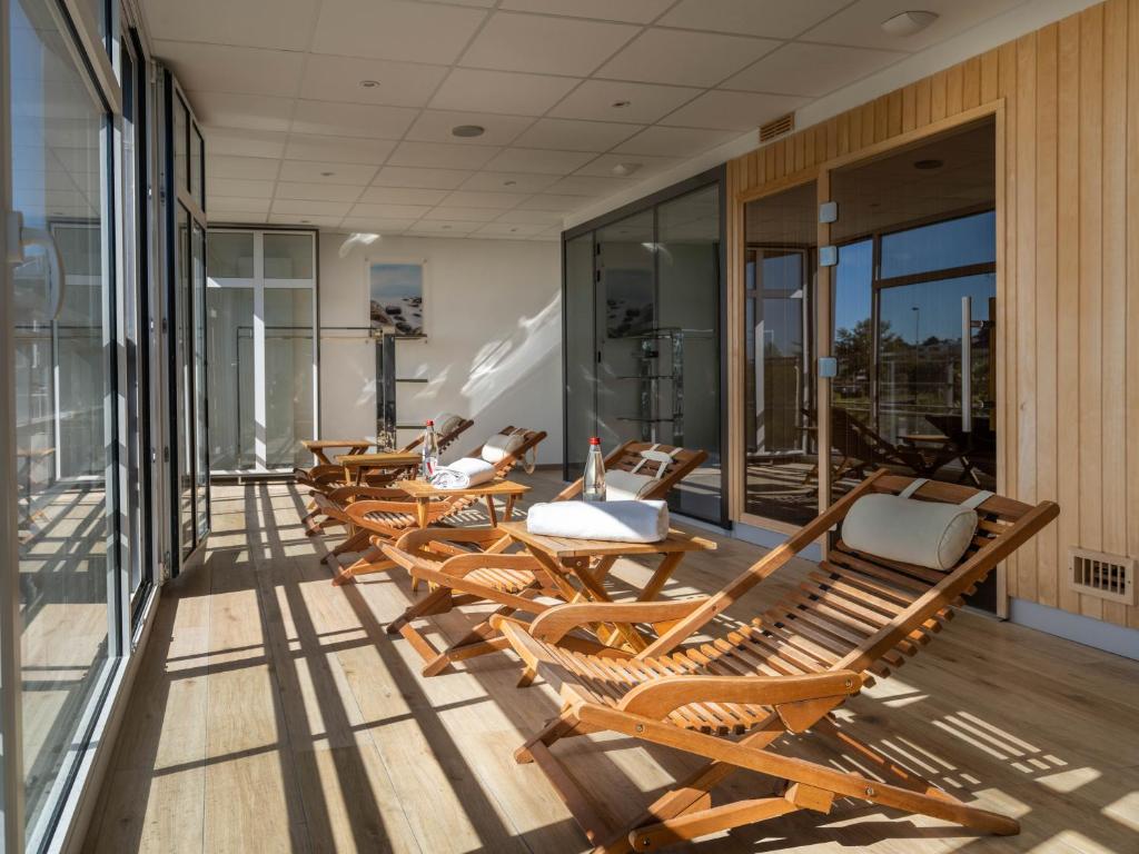 a row of chairs sitting on the balcony of a building at Westotel Le Pouliguen in Le Pouliguen