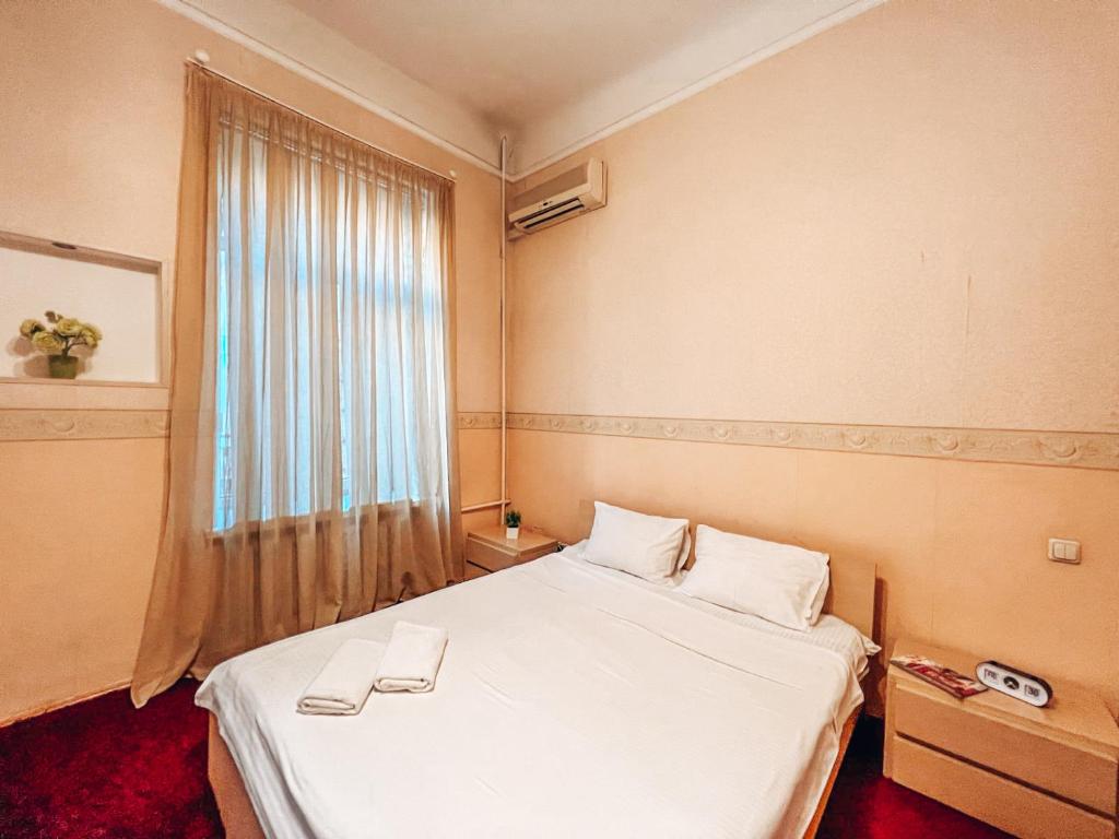 a hotel room with a bed and a window at Apartment - Independence Square in Kyiv
