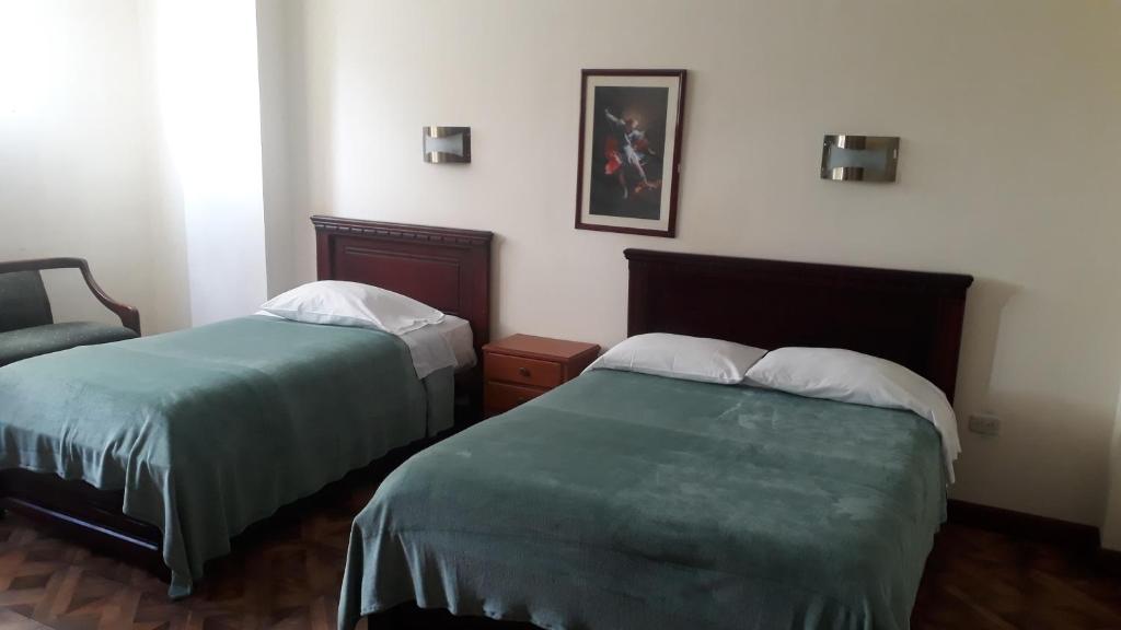 Postel nebo postele na pokoji v ubytování El Cardenal Hotel