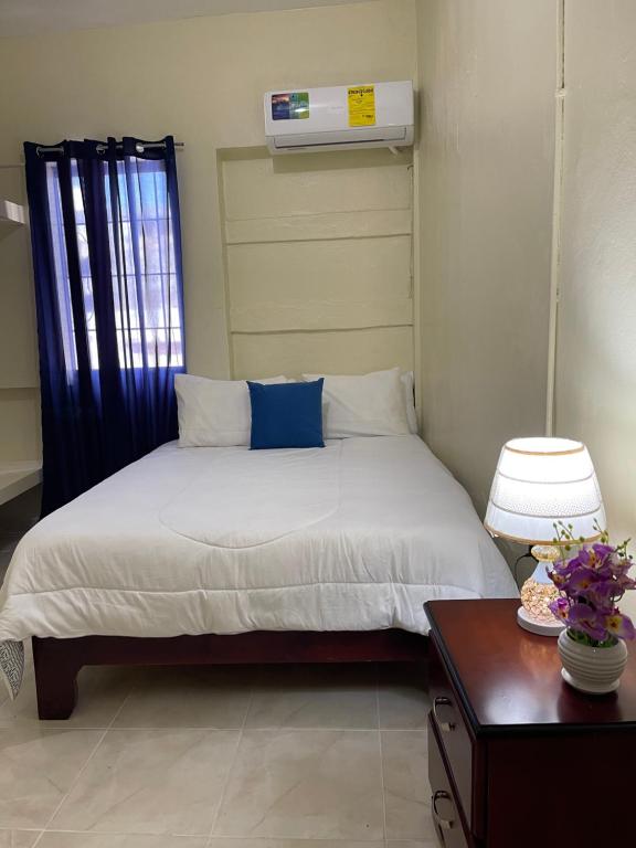 a small bedroom with a bed and a table at VBermor Hotel in Santo Domingo