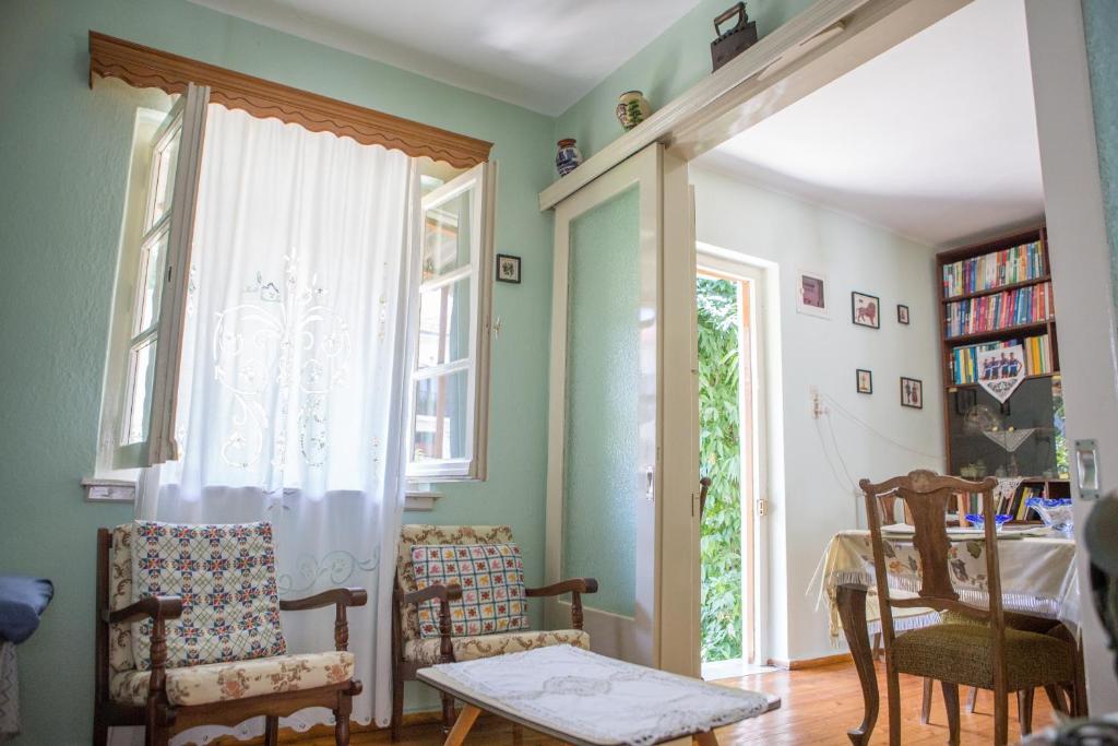 a room with chairs and a table and a window at Traditional House at Central Square in Zagora