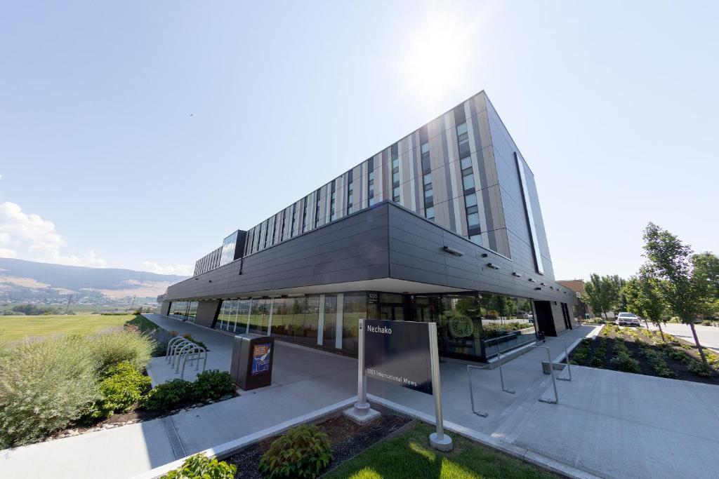 a large glass building with a sign in front of it at UBC Okanagan Campus in Kelowna