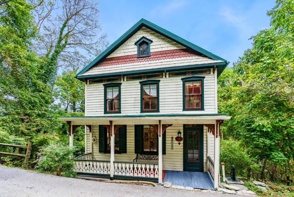 a small white house with a blue roof at Enchanting Cottage, Center of Historic Downtown! in Harpers Ferry