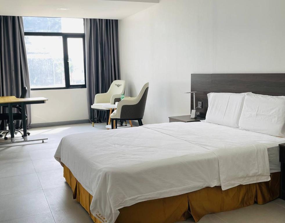 Postel nebo postele na pokoji v ubytování 广东大酒店Guangdon Business Hotel-SM Mall of Asia, SMX & Manila World Trade Center