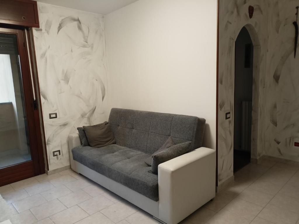 a couch sitting in a room with a wall at Casa Manzoni 