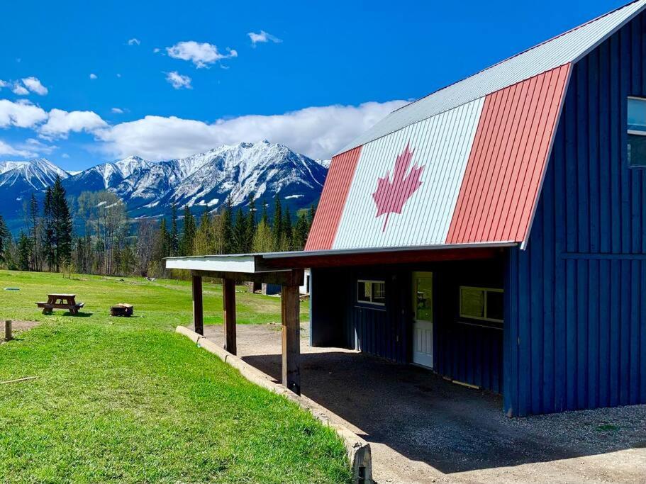a building with a canadian flag on the side of it at Maple Ranch Golden in Golden