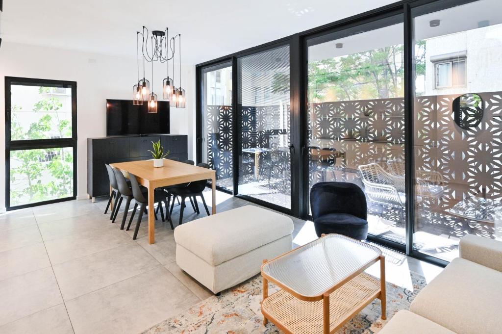 a living room with a table and chairs at Black Panter by HolyGuest in Tel Aviv