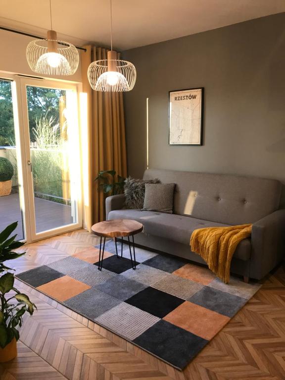 a living room with a couch and a table at Capital Towers RZESZOW, free parking, terrace in Rzeszów