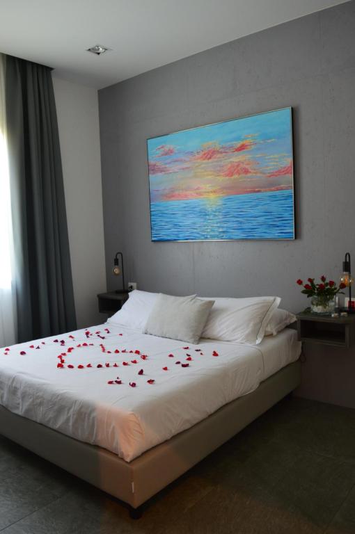 a bedroom with a bed with red roses on it at Bed and breakfast Villa Tota in Catanzaro Lido