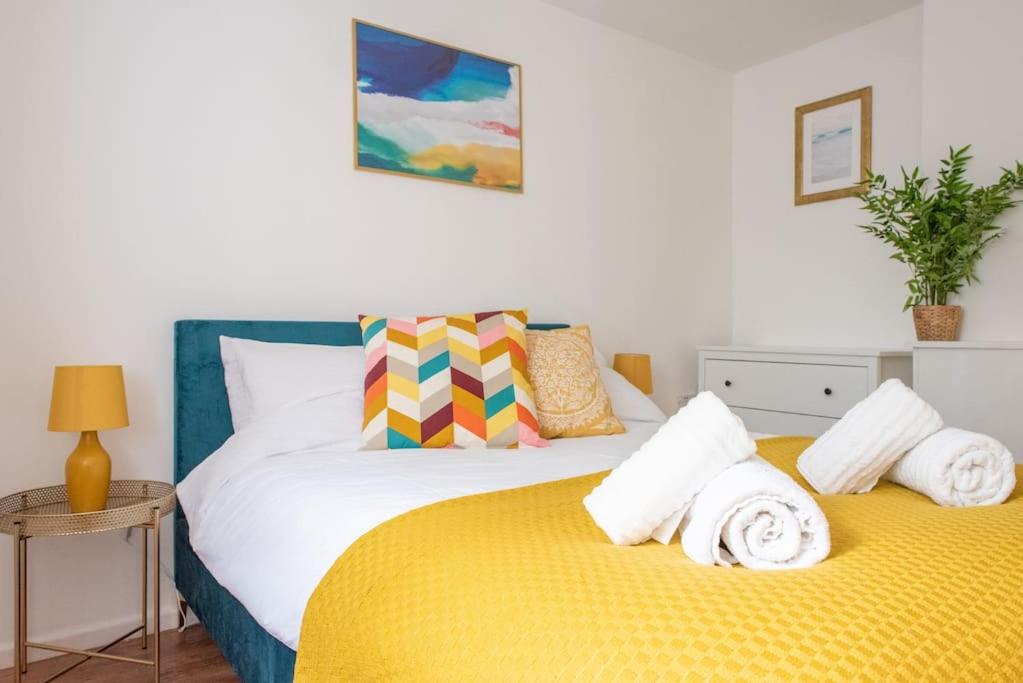 two beds sitting next to each other in a bedroom at Seashells, close to seafront, large private garden in Lyme Regis