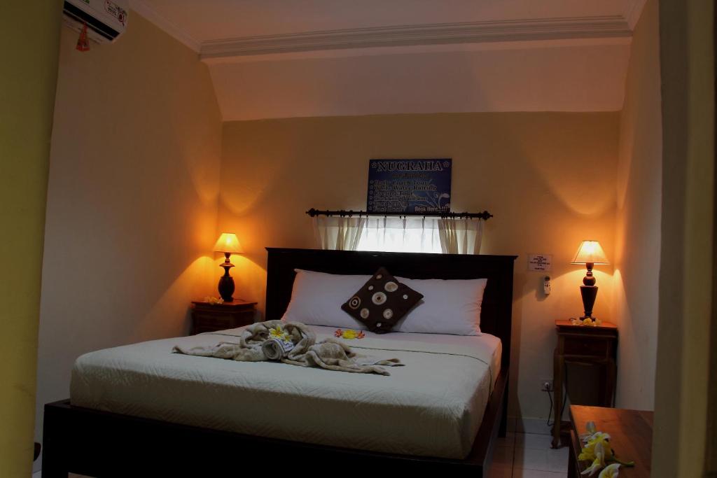 Letto o letti in una camera di Nugraha Guesthouse 1