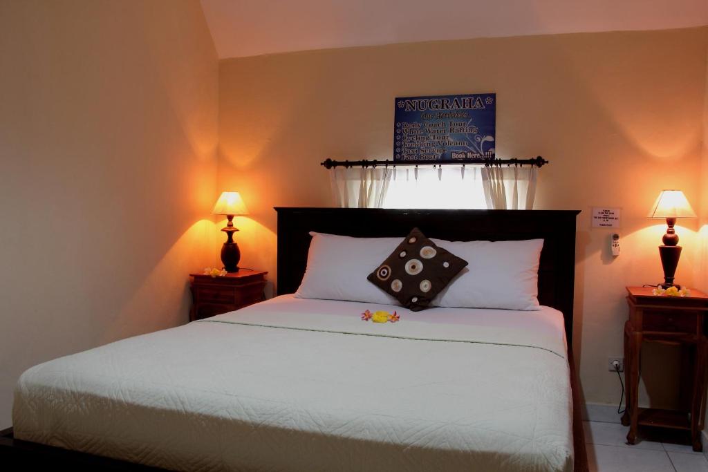 Letto o letti in una camera di Nugraha Guesthouse 1