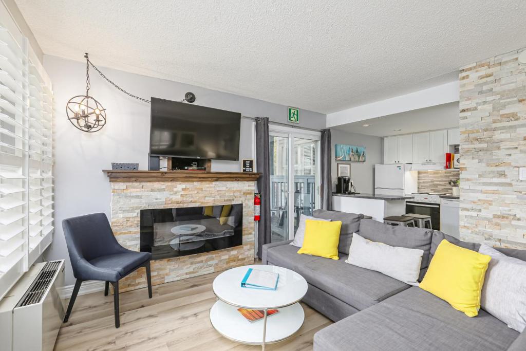 a living room with a couch and a fireplace at Blue Mountain Hideaway at North Creek Resort in Blue Mountains