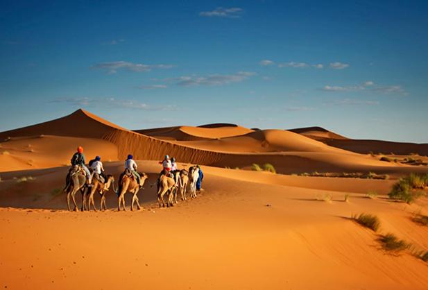a group of people riding horses in the desert at alsaif camp in Bidiyah