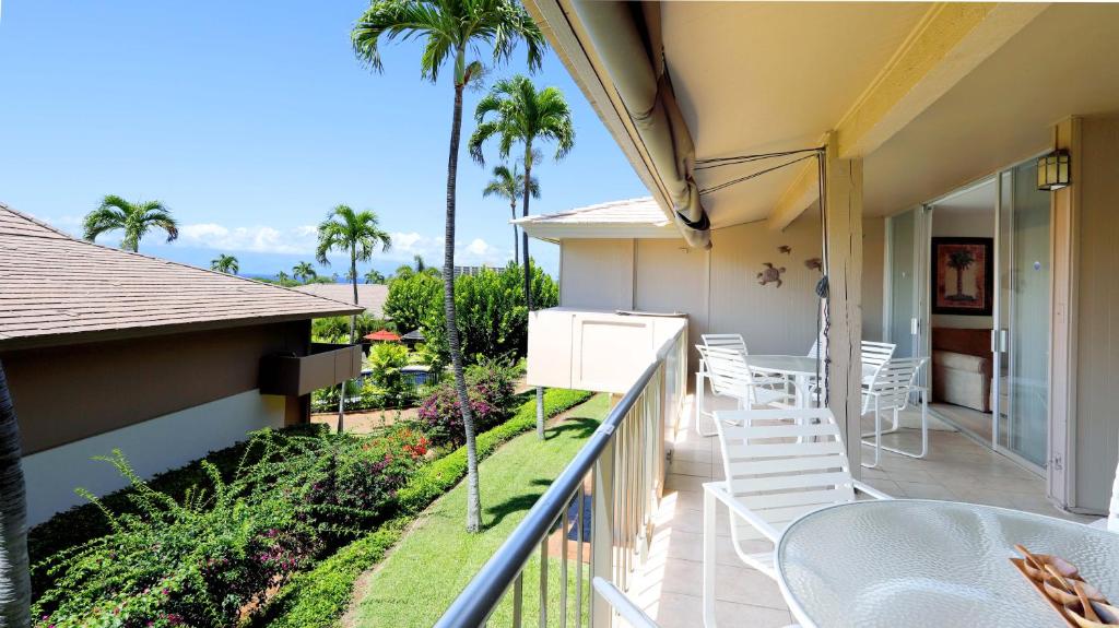 a balcony of a house with a table and chairs at Maui Eldorado D200 - 2 Bedroom in Lahaina