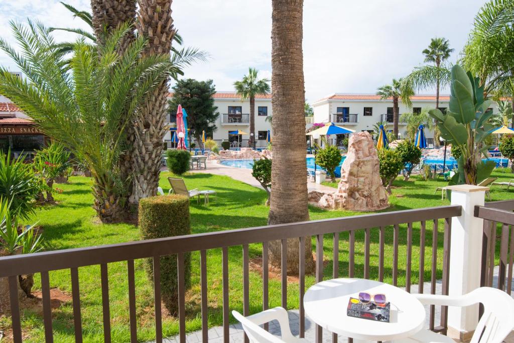 a view of the pool from the balcony of a resort at Loutsiana Deluxe Apts in Ayia Napa