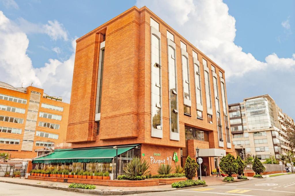 a tall building with a clock on the front of it at Hotel Parque 97 Suites in Bogotá