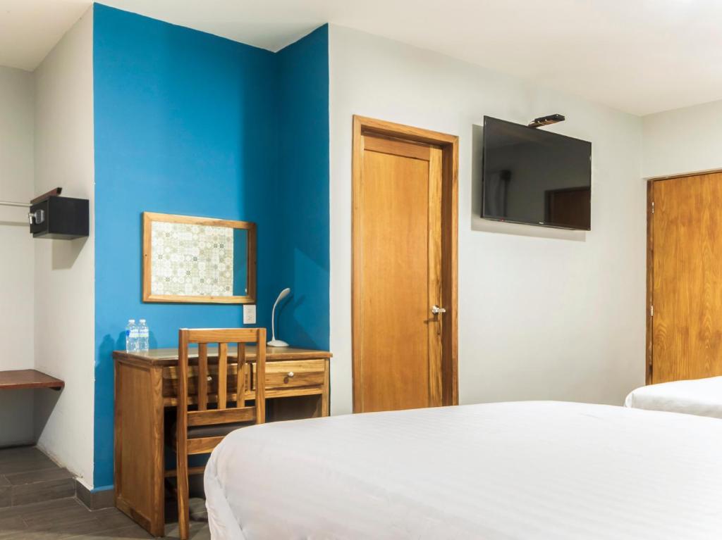 Postel nebo postele na pokoji v ubytování Hotel Meson del Barrio