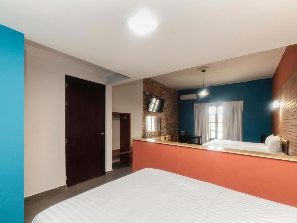 Postel nebo postele na pokoji v ubytování Hotel Meson del Barrio