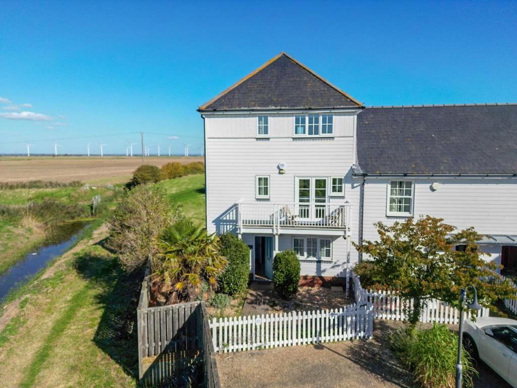 an aerial view of a white house with a fence at Marine House in Camber