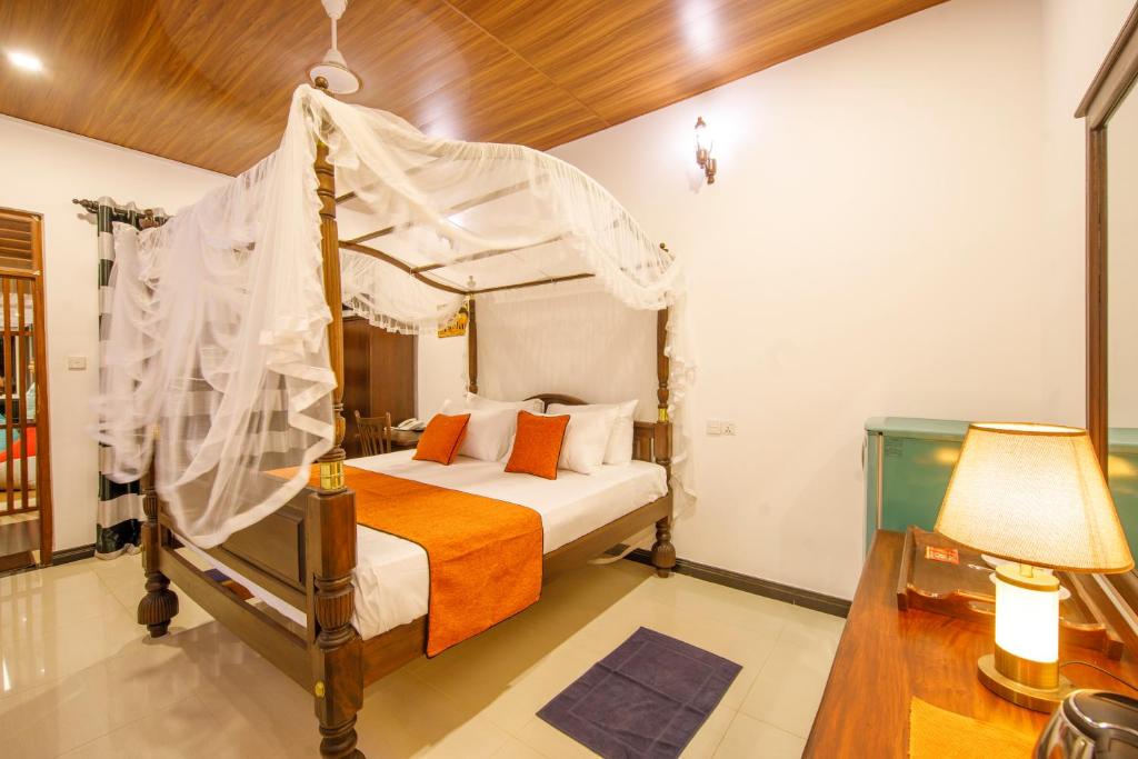 Ένα ή περισσότερα κρεβάτια σε δωμάτιο στο Mimoza Mirissa