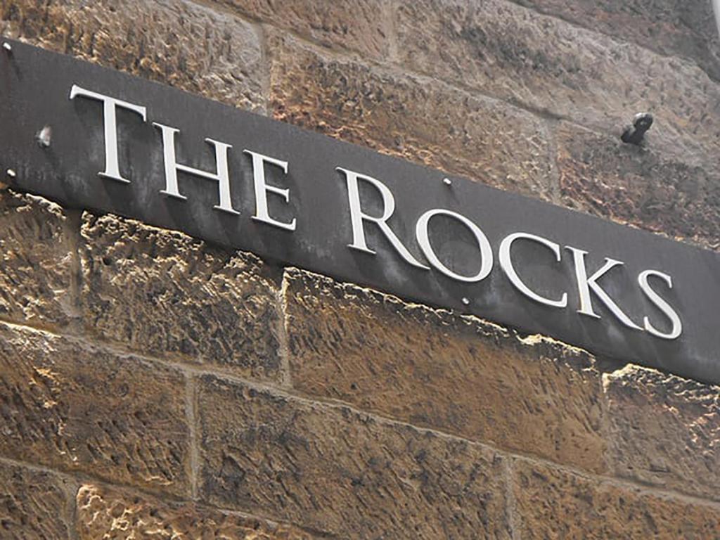 a sign that says the rocks on a brick wall at Kent Terrace in Sydney